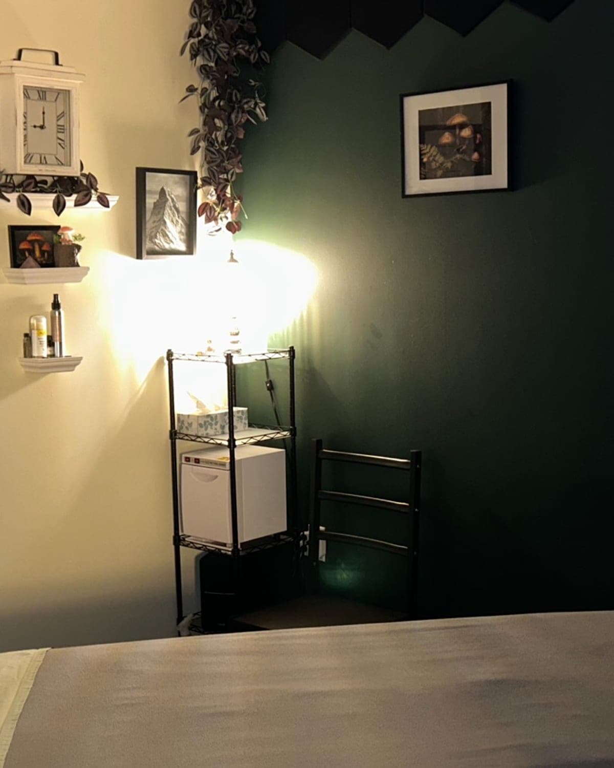 Massage table in a green-walled treatment room at TCH Massage in Olds