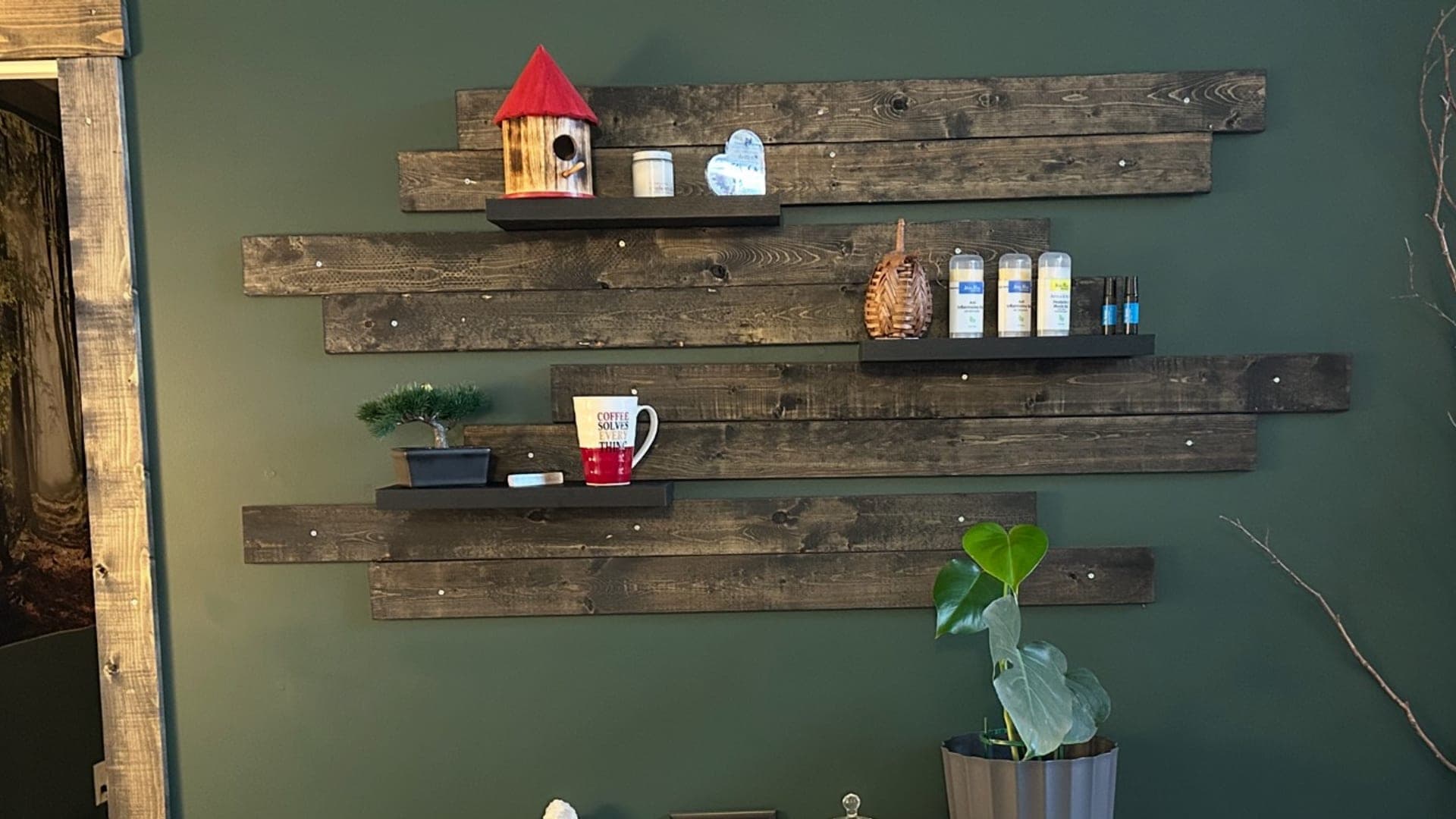 Wood feature wall with display shelves inside the TCH Massage studio in Olds